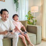 a person and a child sitting on a couch